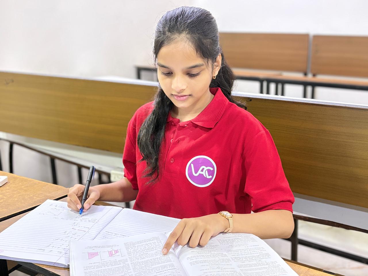 Student solving physics problems in class